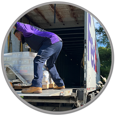 delivery guy unloading a pallet of herbal donations